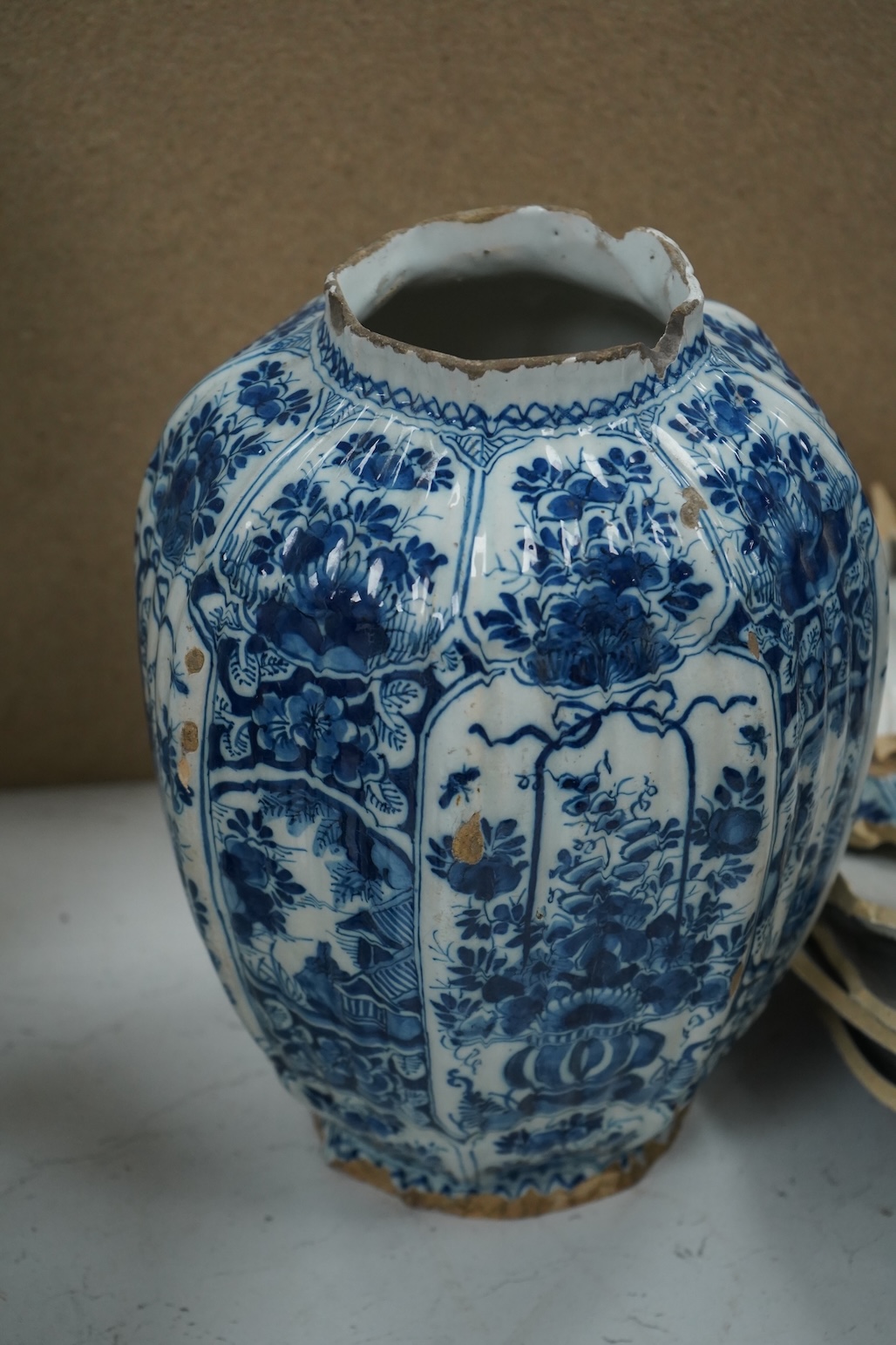 A late 17th century Delft faceted blue and white vase, by Lambartus van Eenhorn, and another broken similar, 29cm high (a.f.)